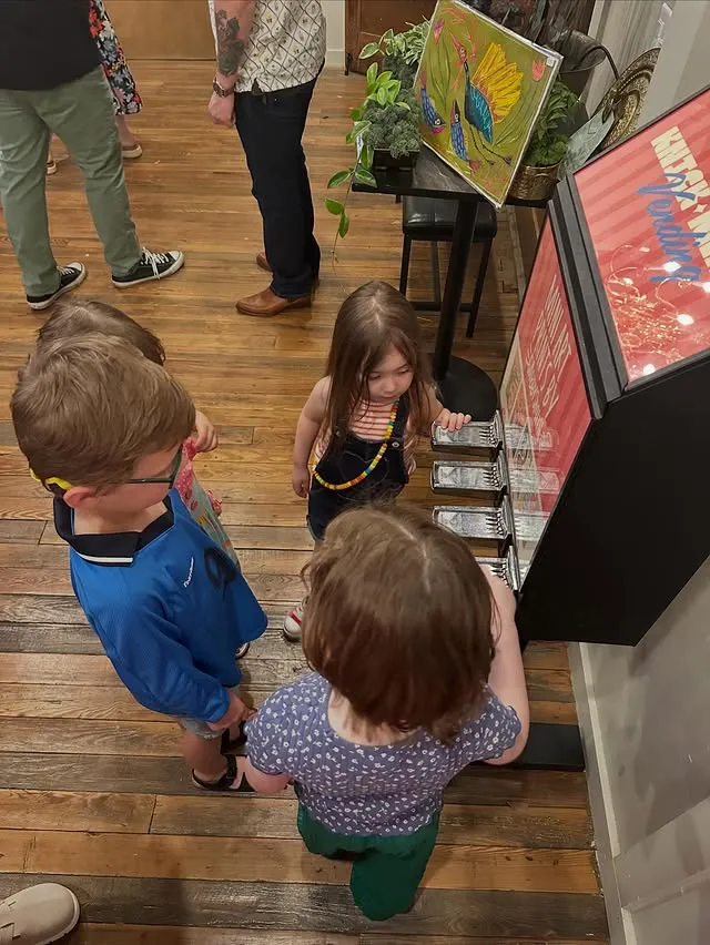 Children crowding around the machine