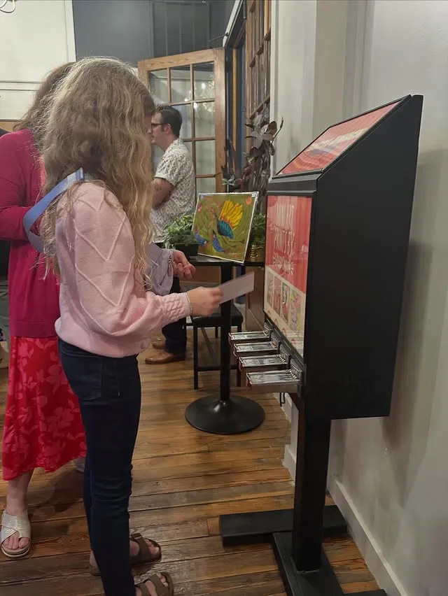 A girl at the machine with her print